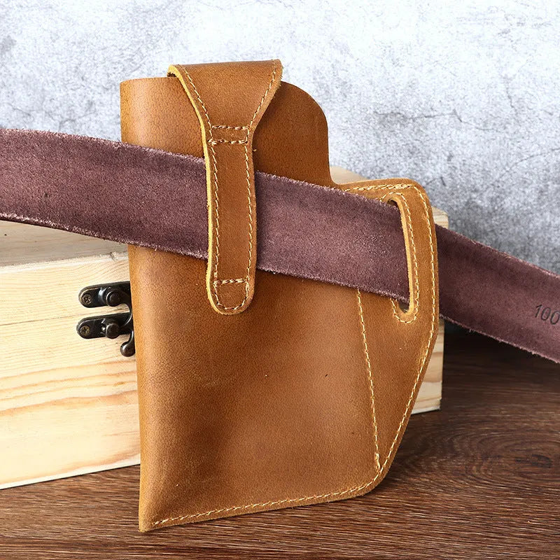 Men's brown leather belt bag with car stitching, shown attached to a belt with phone inside.