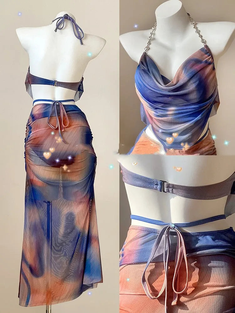 Blue printed women's three-piece bikini set with triangle top, high-waisted briefs, and skirt on hanger.