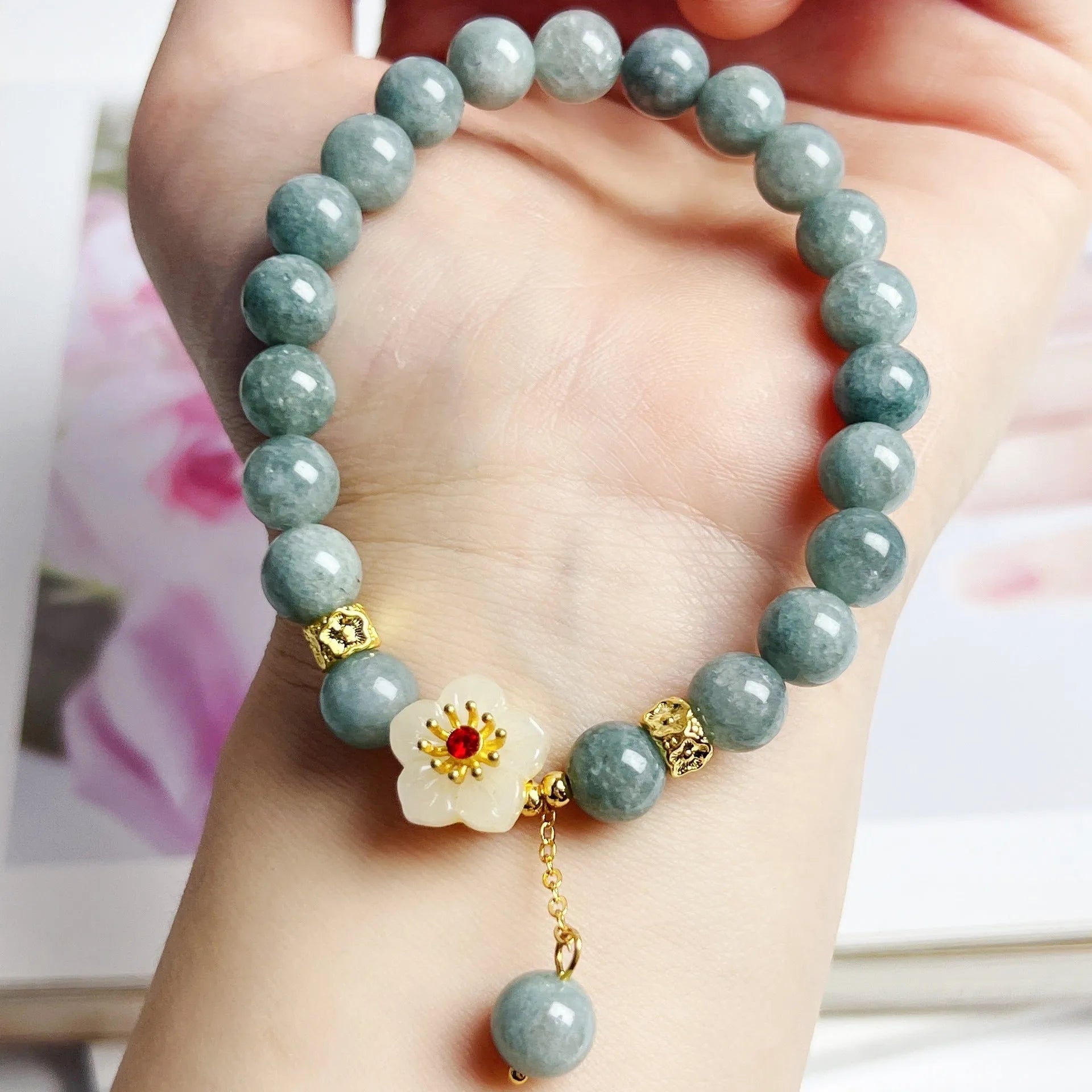 Women's retro style jade bracelet with adjustable rope closure on wrist