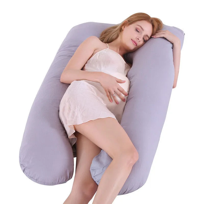 U-shaped pregnancy pillow in light blue ice silk fabric on a bed.