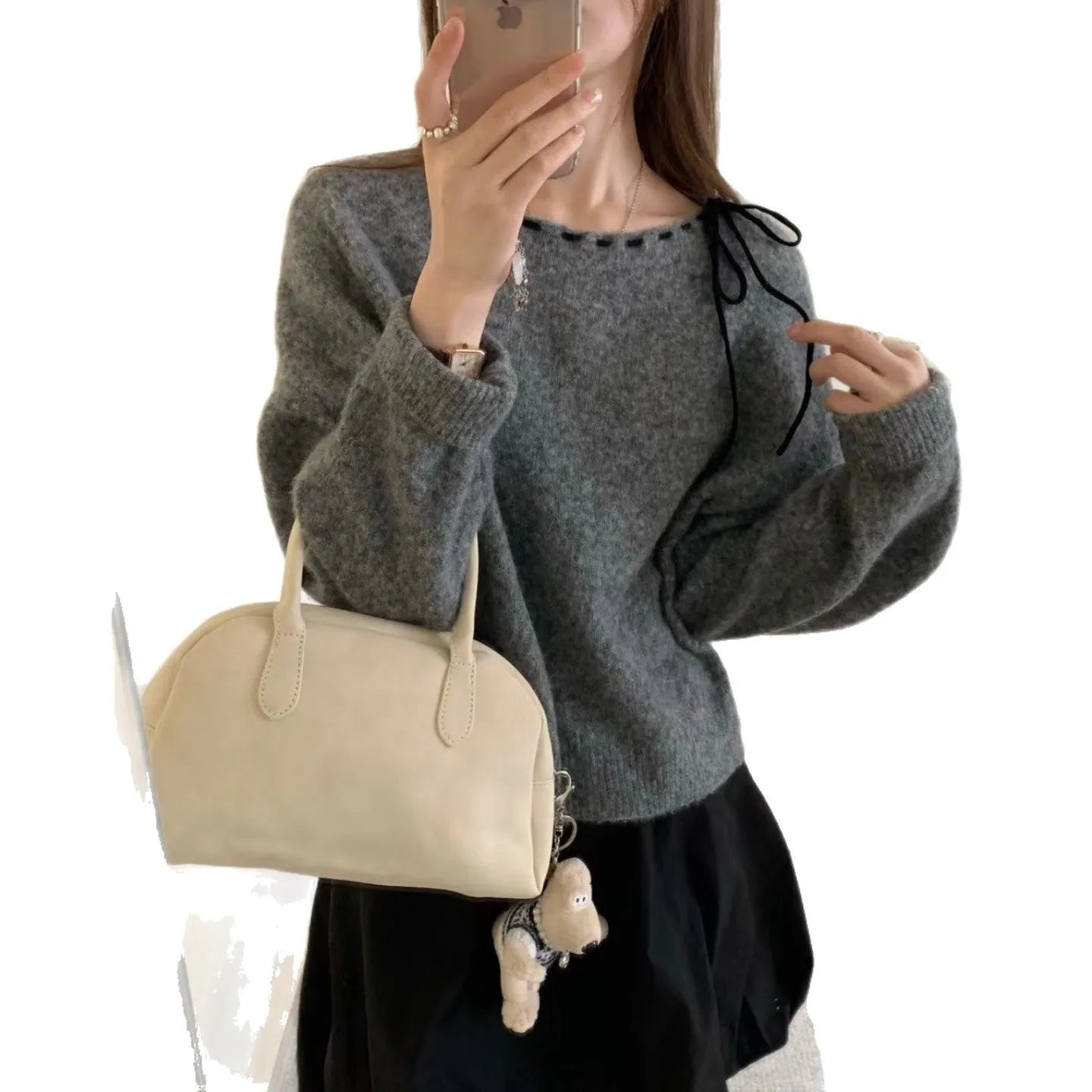 Women's loose-fitting black and grey knitwear pullover sweater on a hanger