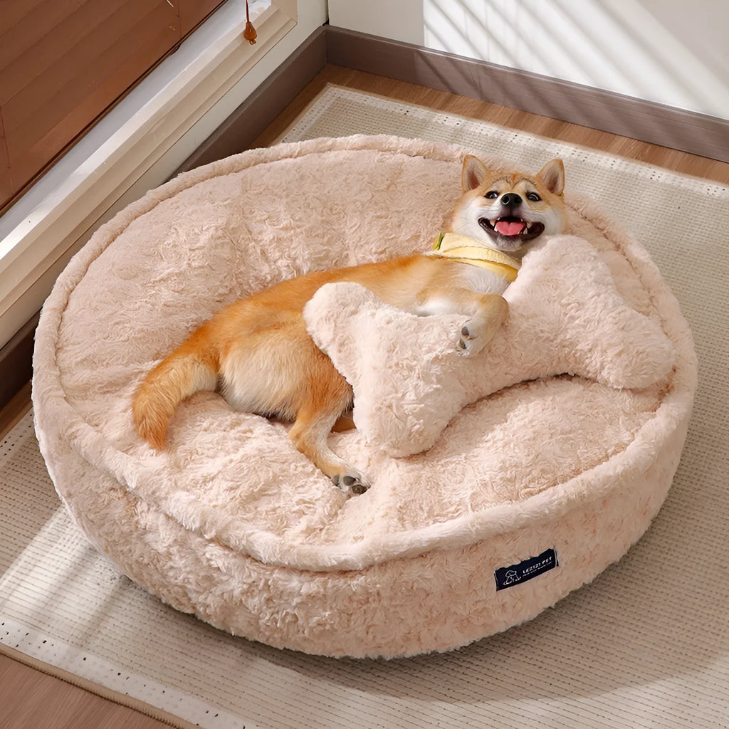 Round nest pet bed with a removable cover in a milk tea colour on a wooden floor