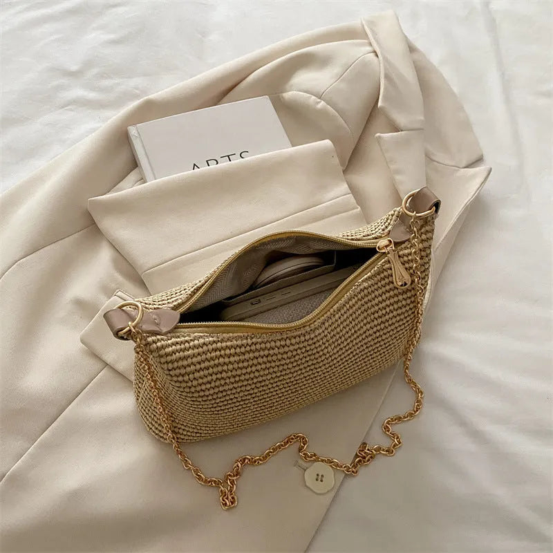 Woven straw crossbody handbag with square shape in khaki colour showing phone pocket
