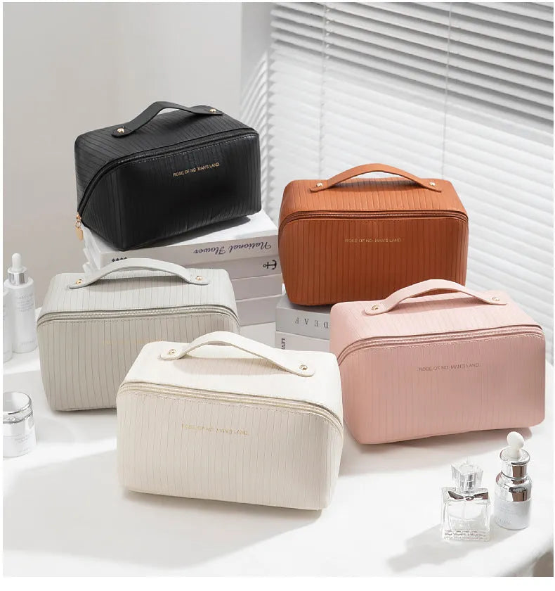 Vertical pattern cubic PU leather makeup bag in beige, shown open to display large capacity interior.