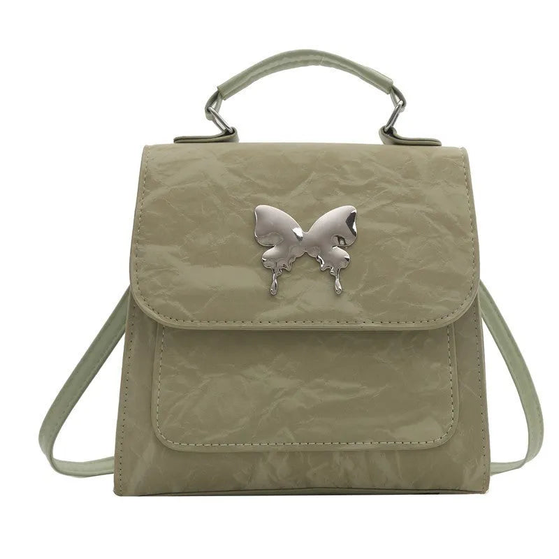 Women's preppy style hand-carry backpack in PU leather with bow detailing and mobile phone compartment