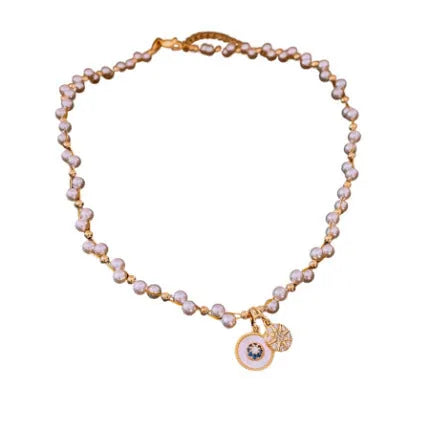 Gold electroplated necklace with round imitation pearl pendant featuring zircon details on adjustable clavicle chain