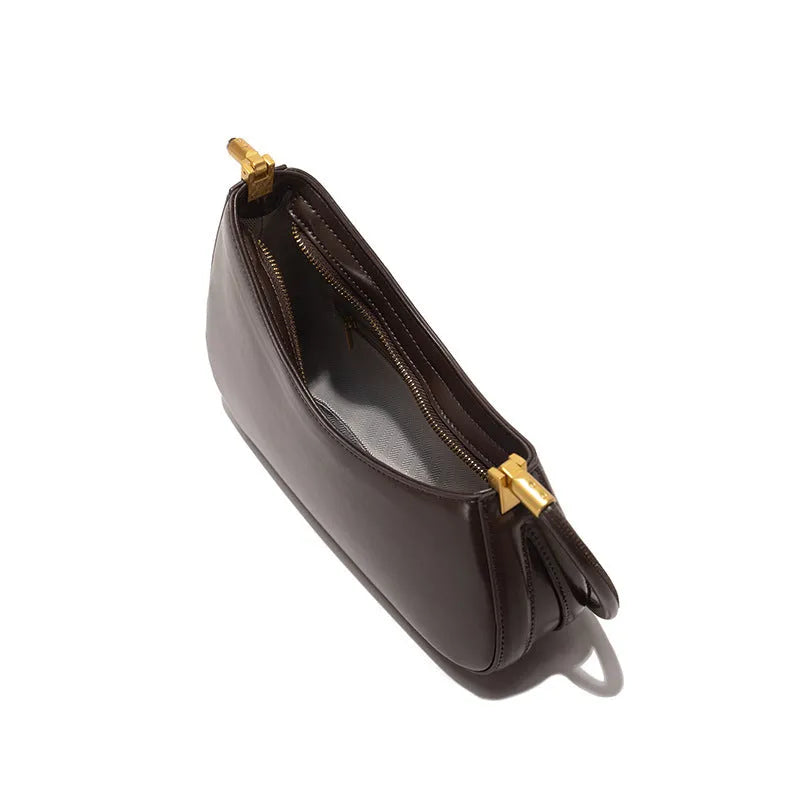 Oval-shaped brown PU leather women's underarm handbag with a single shoulder strap and visible stitching.