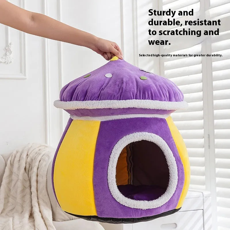 Grey mushroom-shaped plush cat bed with an entrance hole, shown on a wooden floor.