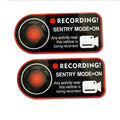 Pair of white rectangular Tesla Sentry Mode warning stickers with black text, 11cm by 5cm.