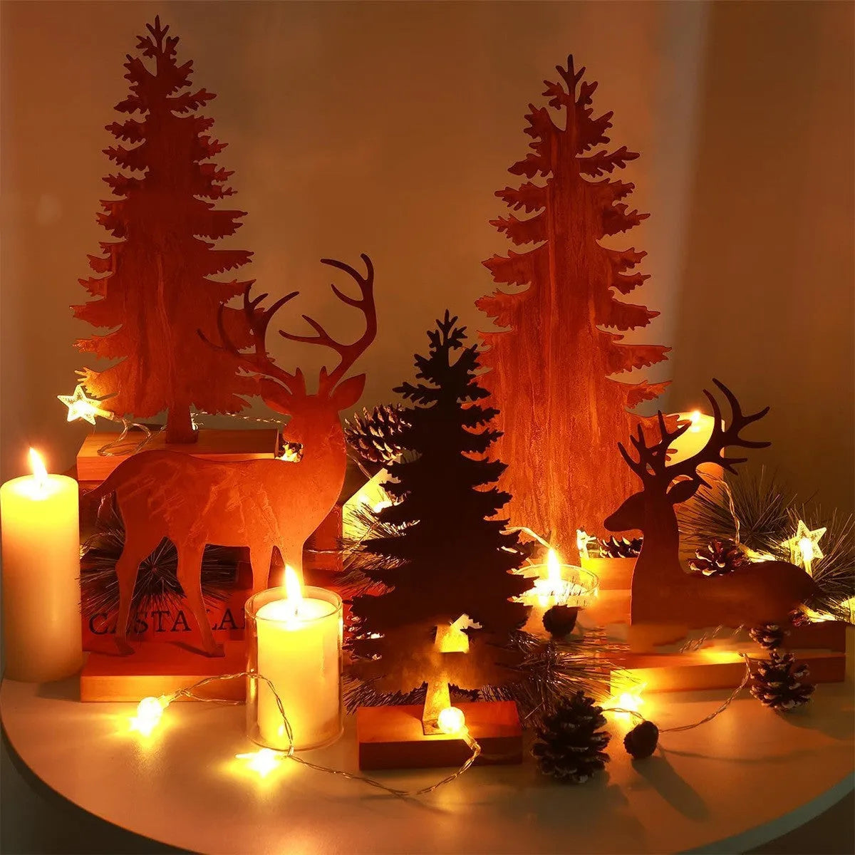 Three rusty metal Christmas ornaments featuring elk and tree silhouettes on a white background
