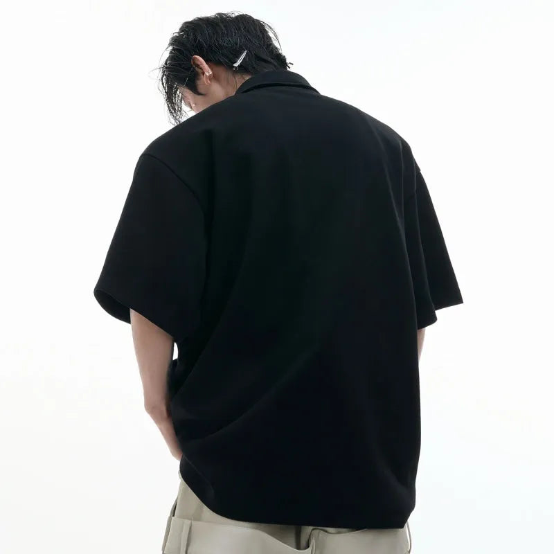 Men's loose fit polo shirt with deconstructed collar and geometric pattern in black