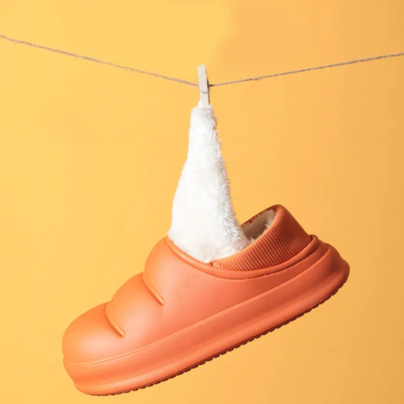 A pair of waterproof EVA couple slippers in green with a plush lining and non-slip sole.