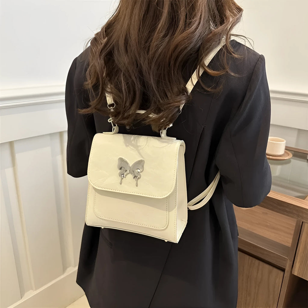 Women's preppy style hand-carry backpack in PU leather with bow detailing and mobile phone compartment