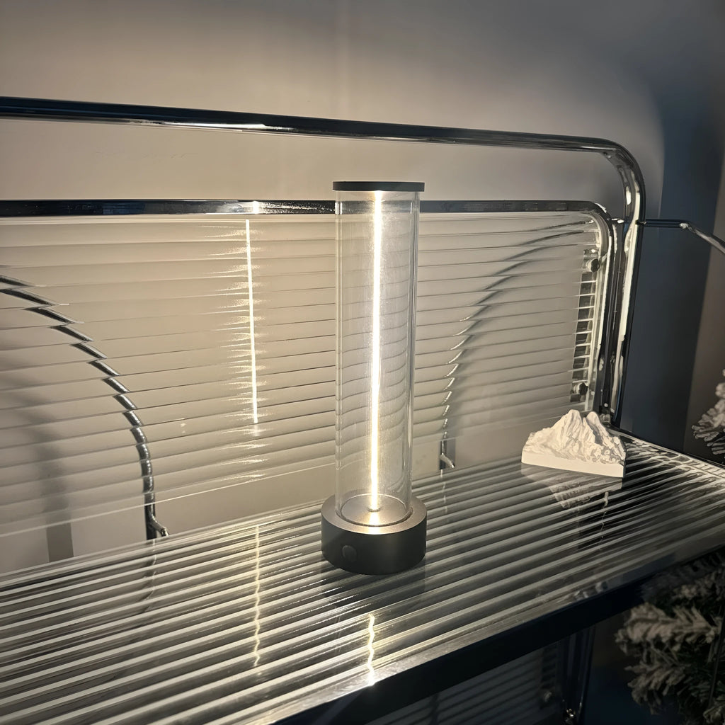 Slim warm white LED light strip with magnetic base for USB charging and attachment to metal surfaces.
