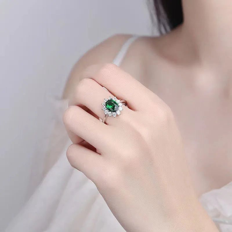 Women's flower-shaped moissanite ring in electroplated copper, shown in sapphire blue colour on a hand.