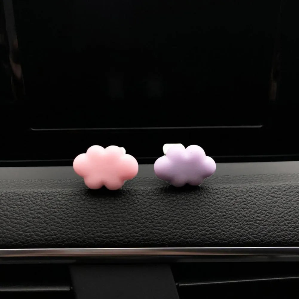 Resin cartoon cloud car fragrance clip in pastel colours mounted on vehicle air vent