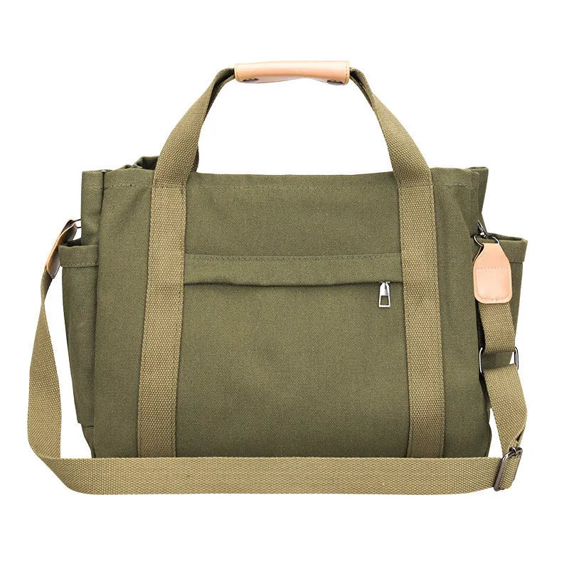 Khaki canvas tote bag with zipper closure showing internal camera pocket and document bag compartments.