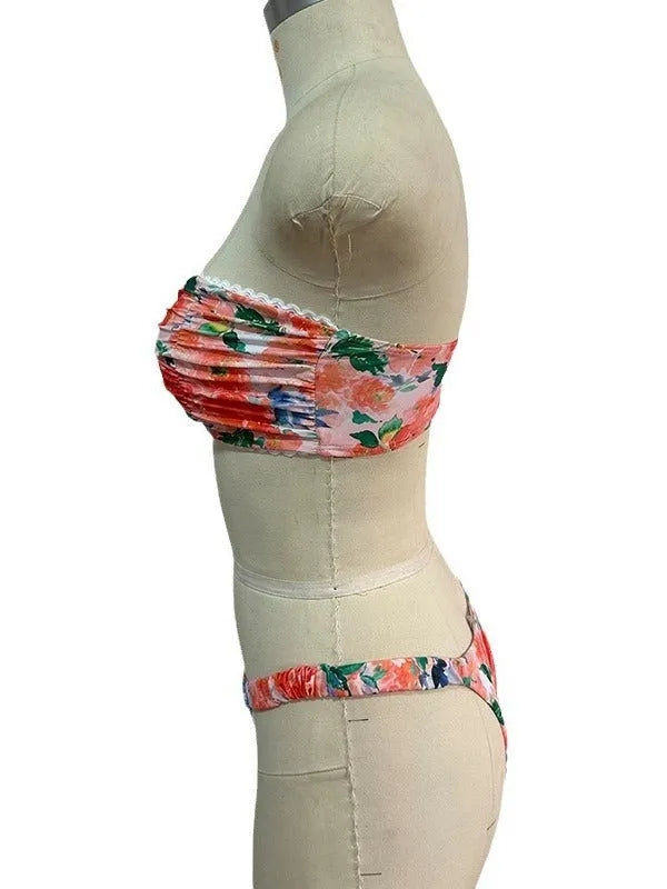 Women's floral print bikini set with lace trim on a backless tube top and matching briefs.