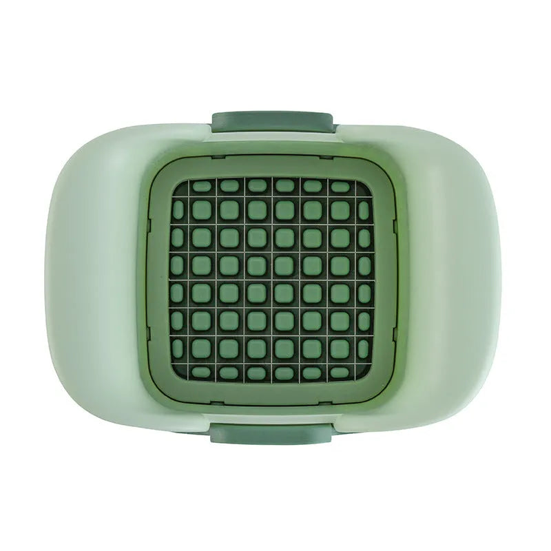 Green hand-operated vegetable chopper with stainless steel blades for slicing onions, potatoes, radishes and cucumbers