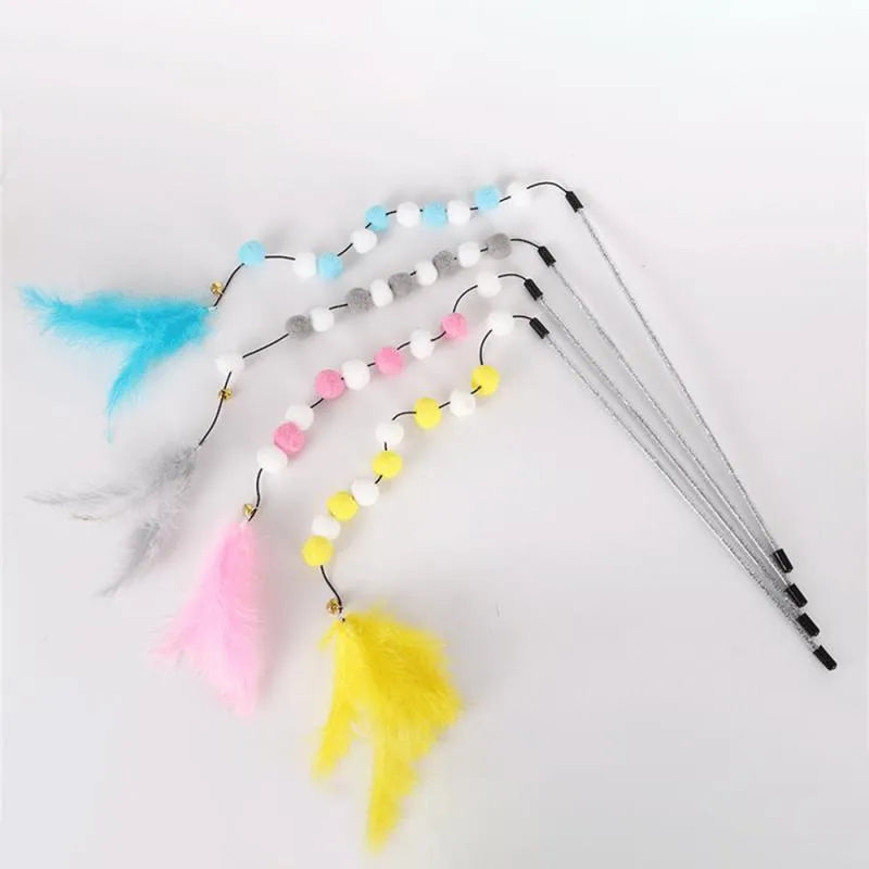 Grey, yellow, and blue acrylic pompon cat teaser stick with feather and bell, shown at 31cm length.