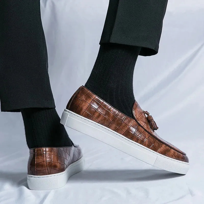 Men's black business casual sneakers with tassel detail on artificial PU upper and rubber sole.
