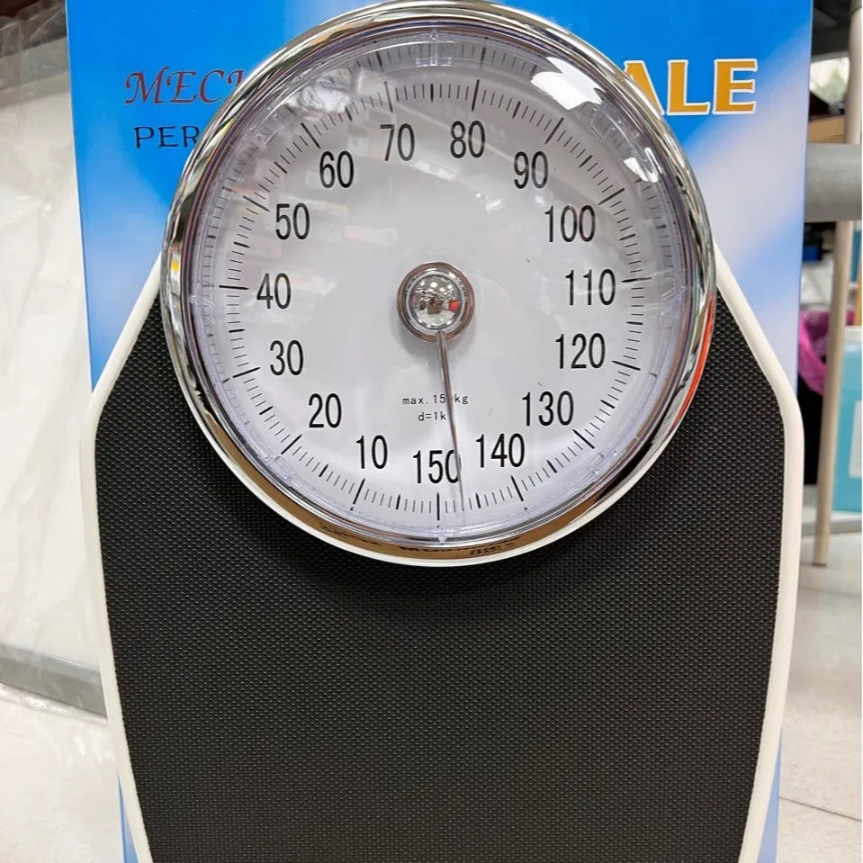 Black mechanical bathroom weight scale with large dial on a 47x35cm platform.