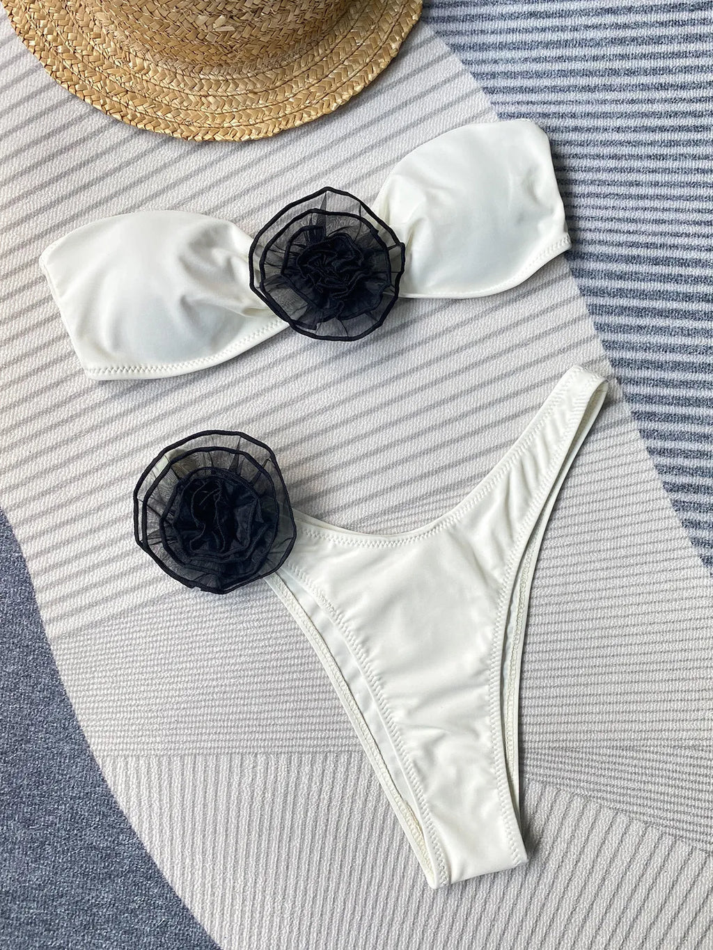 Bikini swimsuit with tube top design and three-dimensional flower detailing in striped pattern