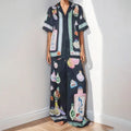 Black women's two-piece cardigan and trousers set with a cartoon animation pattern print.