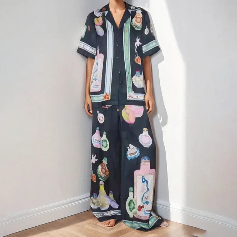 Black women's two-piece cardigan and trousers set with a cartoon animation pattern print.