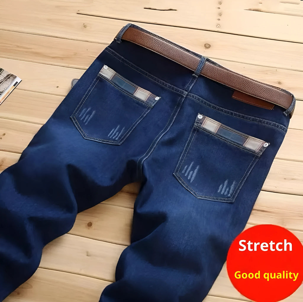Men's dark blue slim-fit stretch skinny denim pants with zipper fly, side view