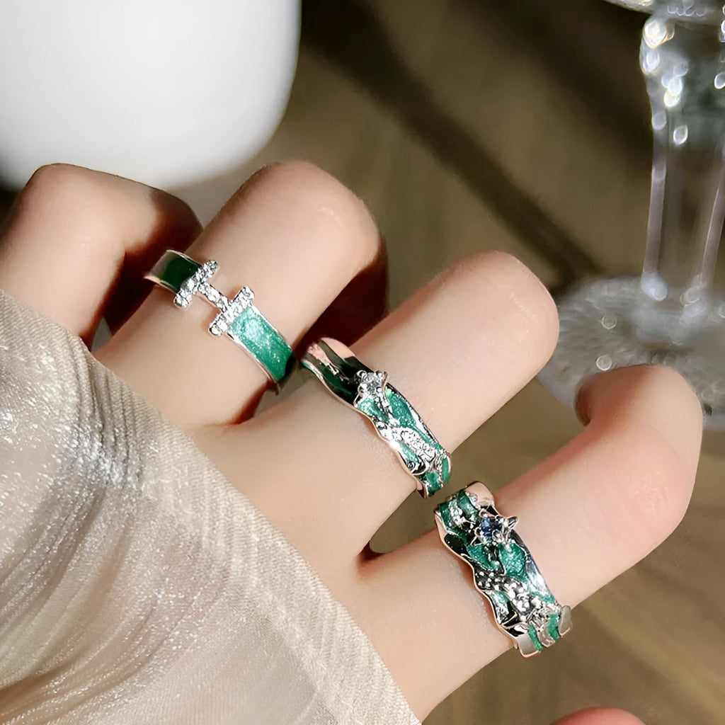Mint green enamel asterism ring with copper folding geometric design on a hand.