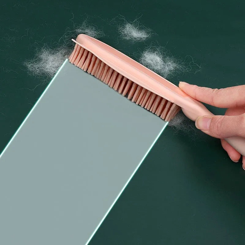 Green dog brush with pet hair remover and massage function next to wool sticker for fabric cleaning