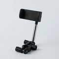 Black ABS car phone holder mounted on a rearview mirror showing 360-degree rotation mechanism