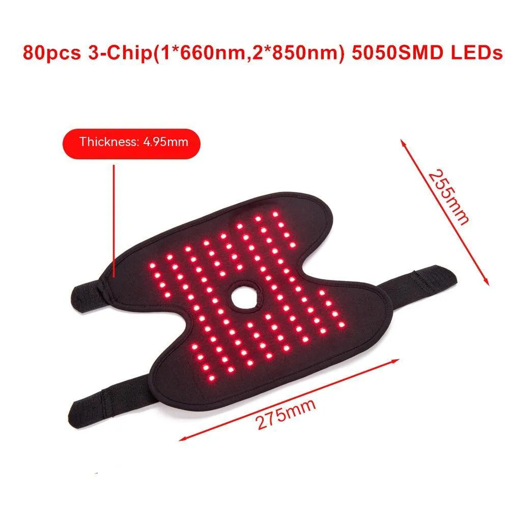 Black fabric ankle support with red light and heating therapy, USB cable, on a flat surface