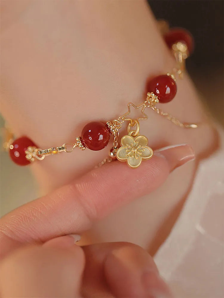 Red agate double layer women's bracelet with floral peach blossom charms on adjustable fastening