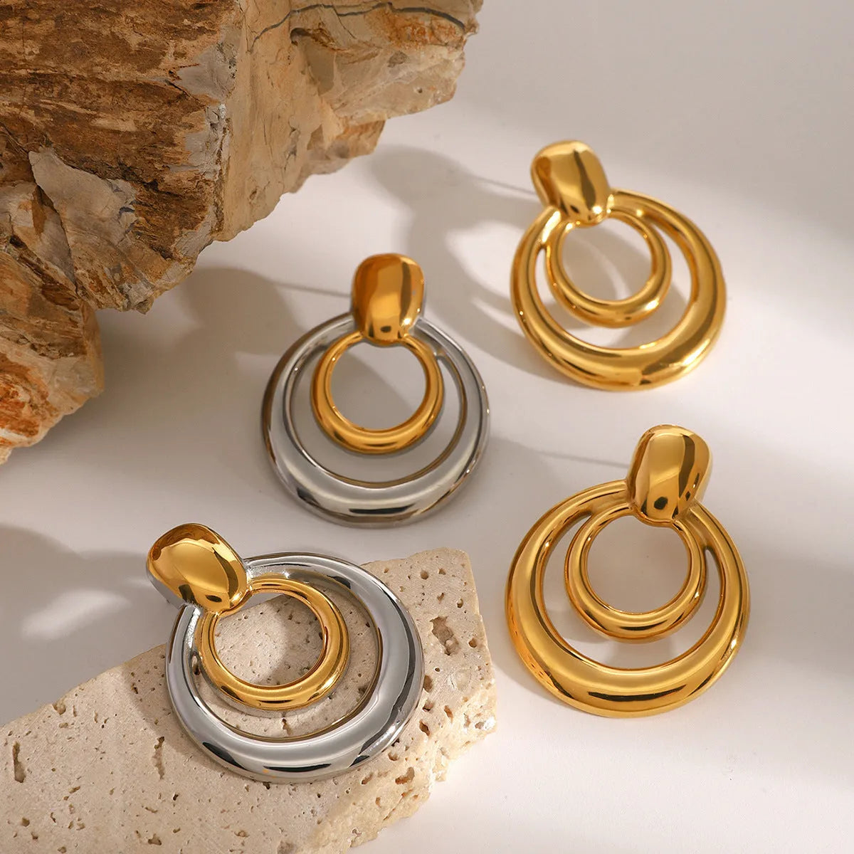 Round golden hollow stud earrings with double layer construction and 18K gold plating