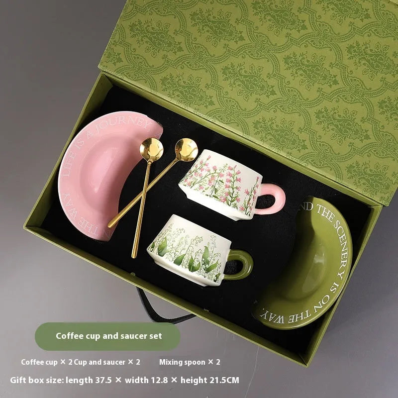 Ceramic coffee cup and saucer set with two cups, two saucers, and two spoons