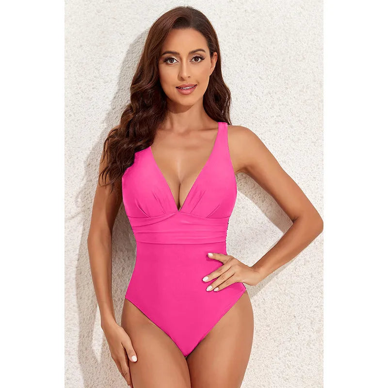 Women's solid colour cross-shoulder one-piece swimsuit in minimalist design for swimming activities