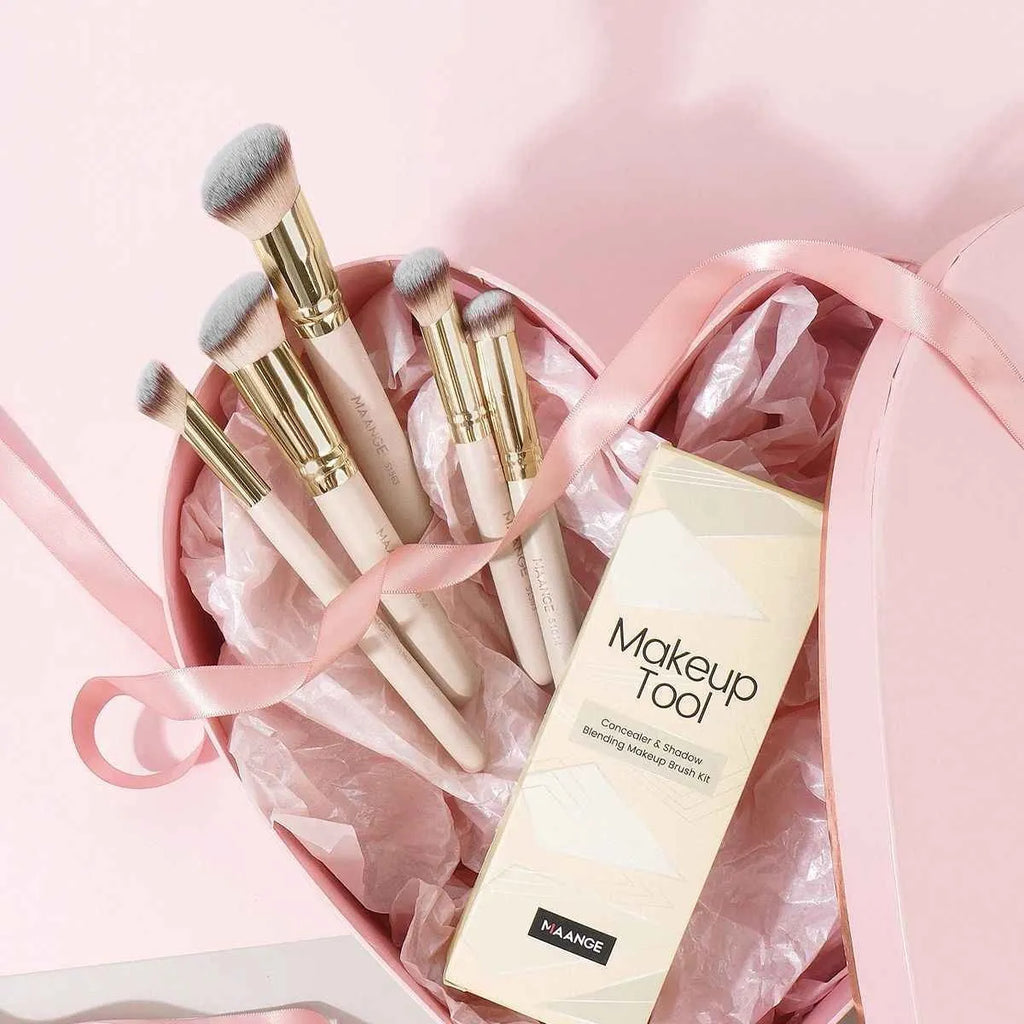 Five apricot coloured angled makeup brushes with synthetic bristles for foundation and powder application