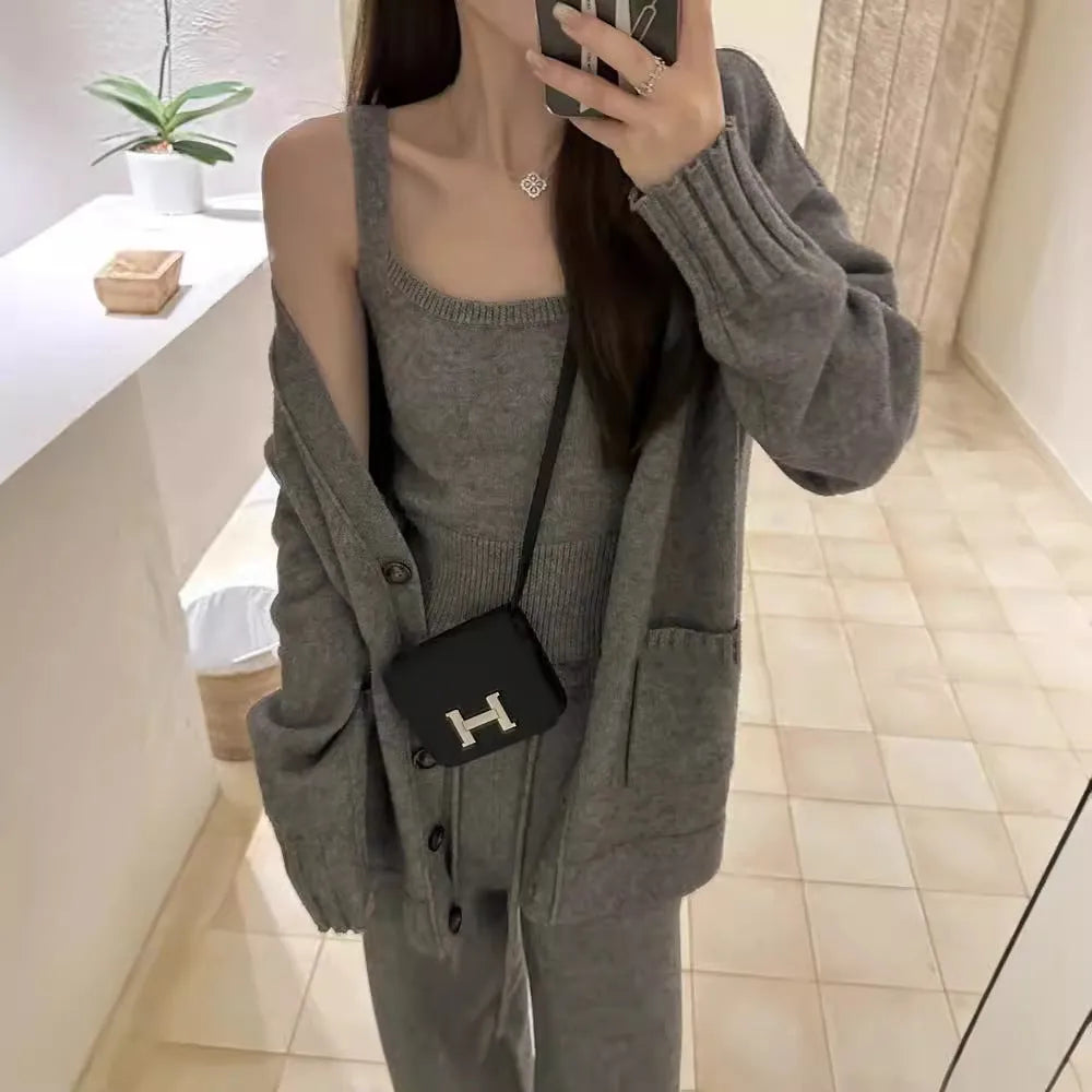 Women's light brown knit cardigan vest and trousers three-piece set laid flat.