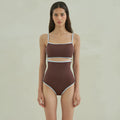 Brown women's one-piece swimsuit with triangle top design on a mannequin