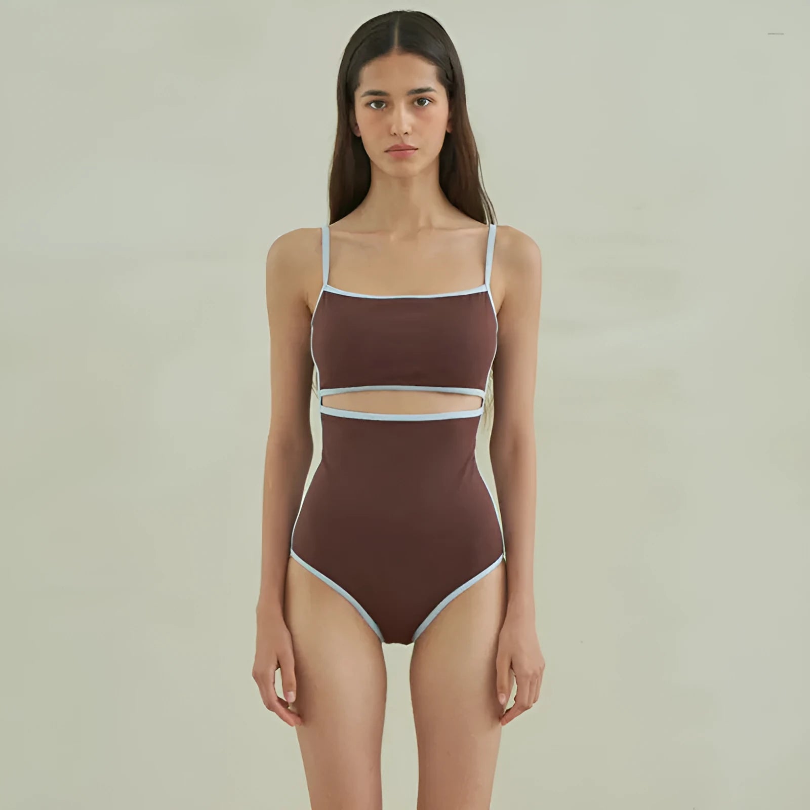 Brown women's one-piece swimsuit with triangle top design on a mannequin