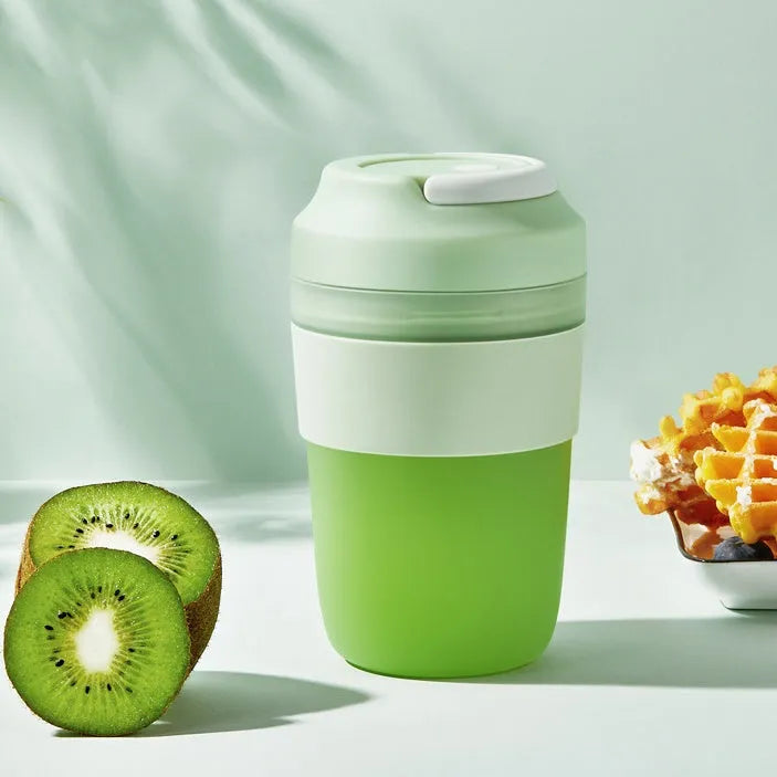 Portable purple rechargeable blender cup with four stainless steel blades, 400ml capacity, shown with USB cable.