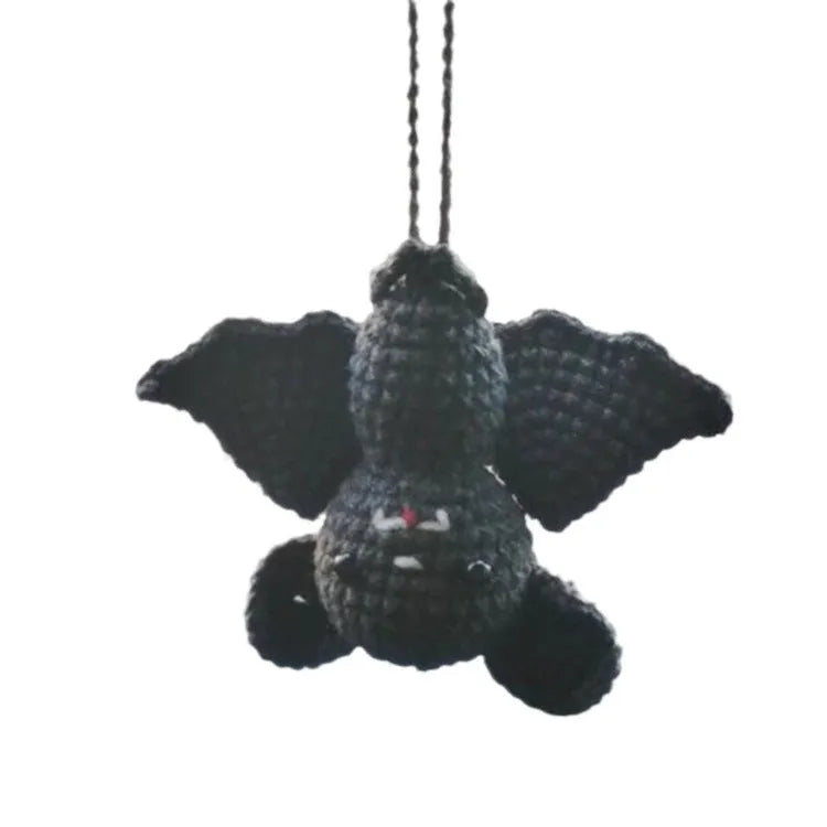 Plush hand-woven car hanging ornament with a selection of cartoon designs like ghosts and pumpkins.