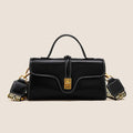 Brown Cambridge-style crossbody messenger bag with clamshell opening and lock detail on a table.