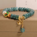 Women's blue water jade abacus bead bracelet with alloy inlay and white agate accents