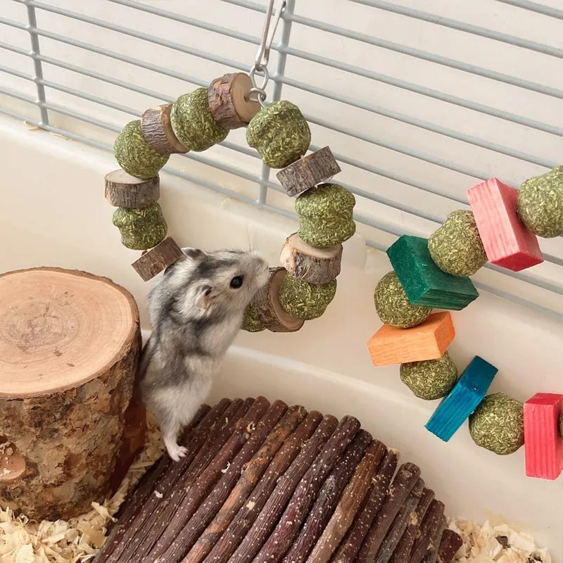Hamster chew toy with decorative ring and straw ball for guinea pigs and rabbits