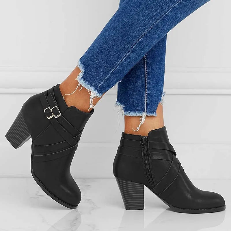 Women's grey short ankle boots with a block heel, side zipper, and buckle strap on a white background.