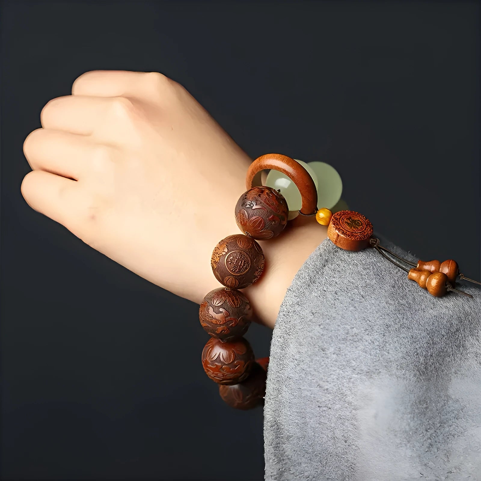 Rosewood bracelet with carved Fu character design showing 20mm beads on wrist