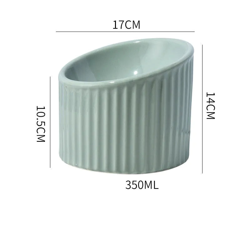 Ceramic elevated cat bowl in light green colour, showing its raised height and round, whisker-friendly shape.